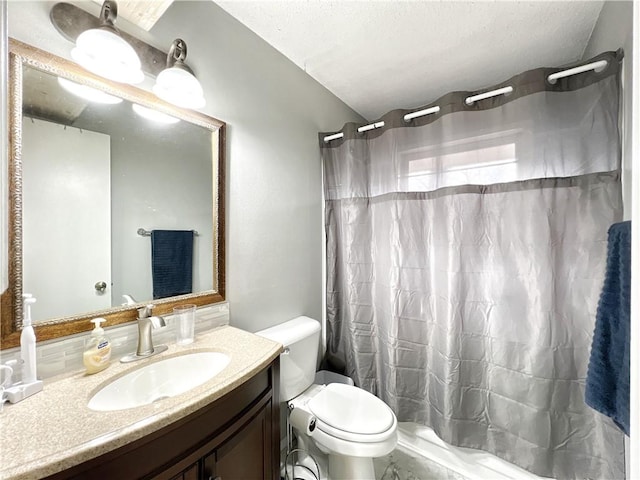 bathroom featuring vanity, a shower with shower curtain, toilet, and a textured ceiling