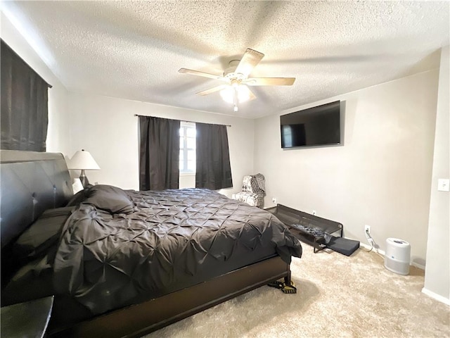 bedroom featuring carpet flooring, a ceiling fan, baseboards, and a textured ceiling