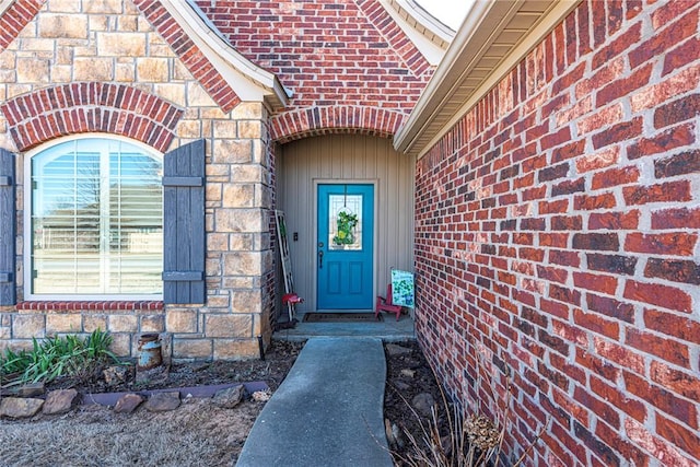 property entrance featuring brick siding and stone siding