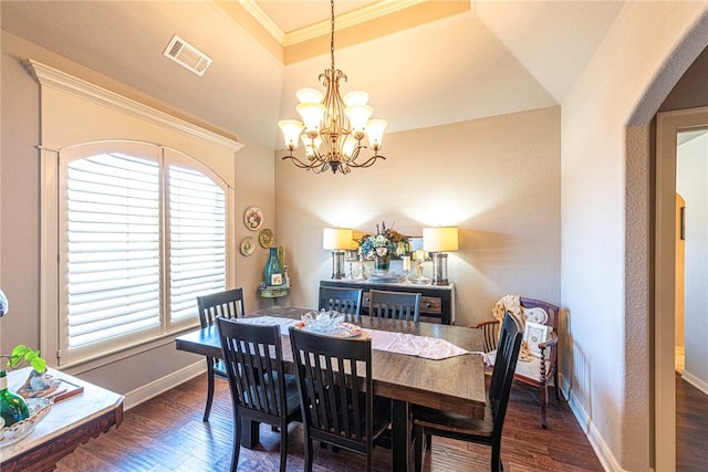 dining area with visible vents, baseboards, wood finished floors, and crown molding