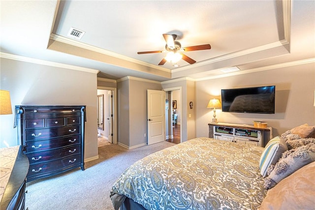 bedroom featuring visible vents, crown molding, baseboards, carpet, and a tray ceiling