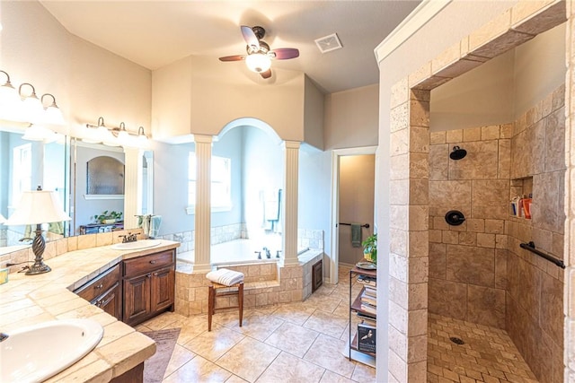 full bath featuring decorative columns, tiled shower, visible vents, and a bath