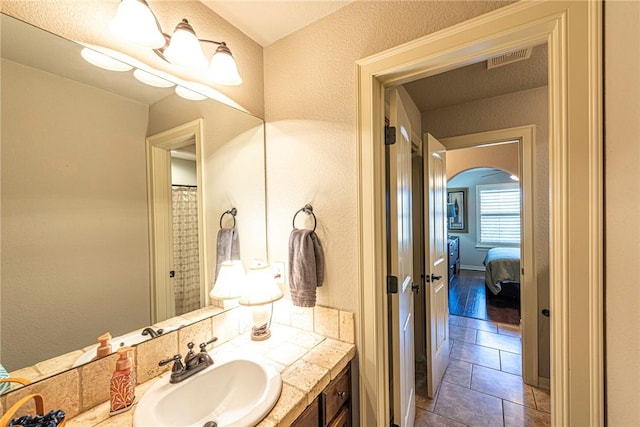 full bath featuring vanity, visible vents, and tile patterned flooring