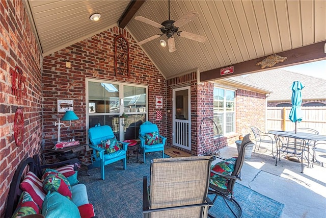 view of patio with outdoor dining space, ceiling fan, and fence