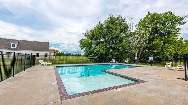 community pool featuring a patio area and fence