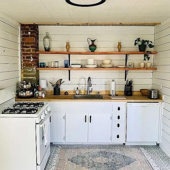 bar featuring white appliances and a sink