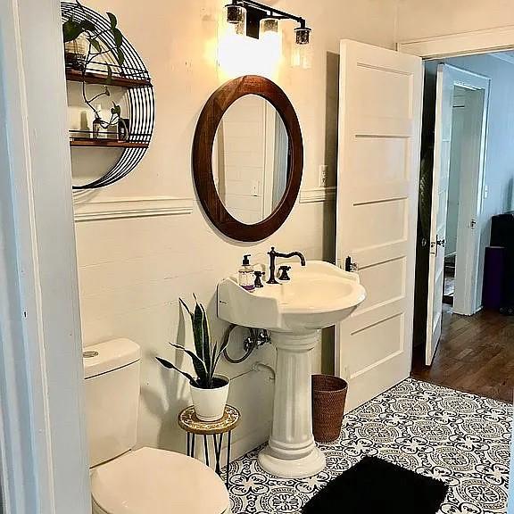 half bath featuring toilet and tile patterned flooring