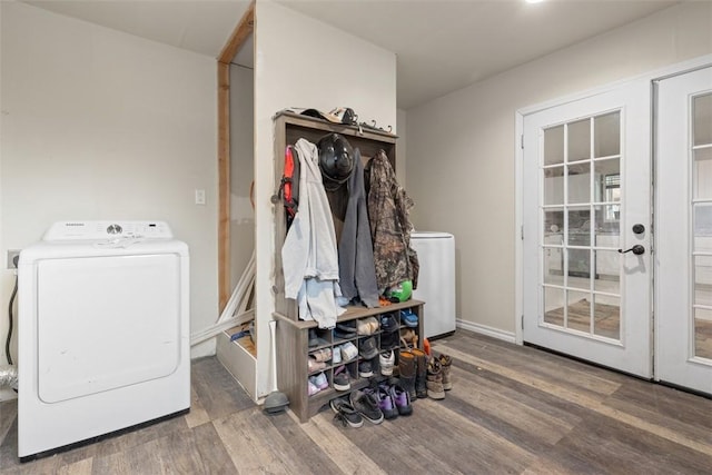 clothes washing area with separate washer and dryer, wood finished floors, and laundry area