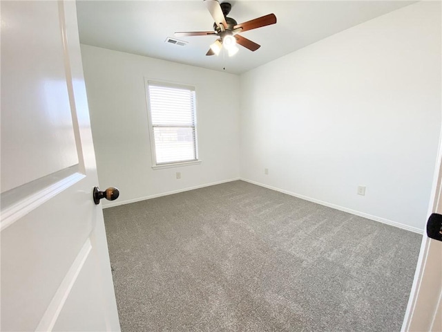 unfurnished room featuring baseboards, visible vents, carpet floors, and ceiling fan