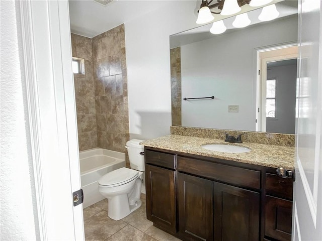 bathroom featuring tile patterned flooring, toilet, vanity, and shower / washtub combination