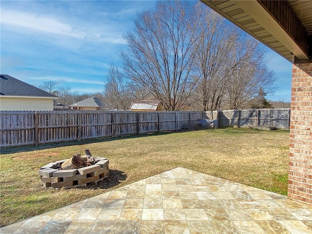 view of yard with a patio, a fire pit, and a fenced backyard