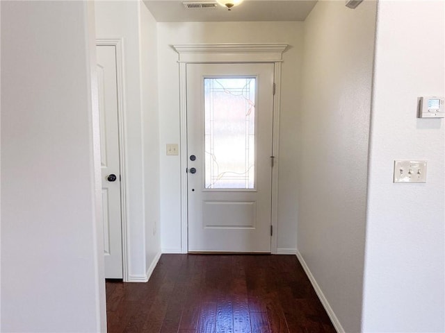 doorway featuring dark wood finished floors, visible vents, and baseboards