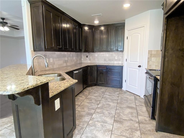 kitchen featuring electric range, a sink, stainless steel dishwasher, a peninsula, and light stone countertops