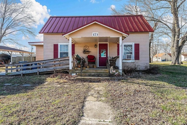 view of front of house with covered porch and metal roof