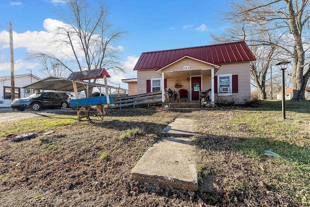 view of front of home featuring a porch, a carport, and metal roof