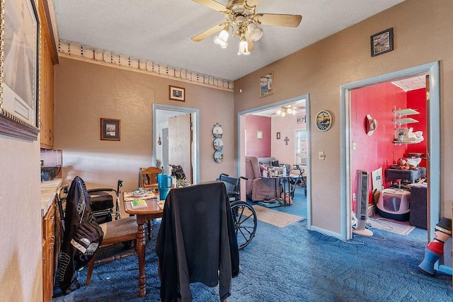 dining room with baseboards, ceiling fan, carpet, a textured wall, and a textured ceiling