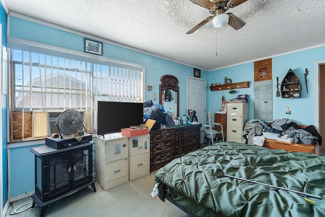 carpeted bedroom with ceiling fan, a textured ceiling, and ornamental molding