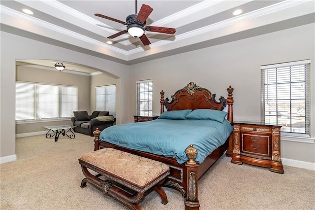 carpeted bedroom with multiple windows, arched walkways, and ornamental molding