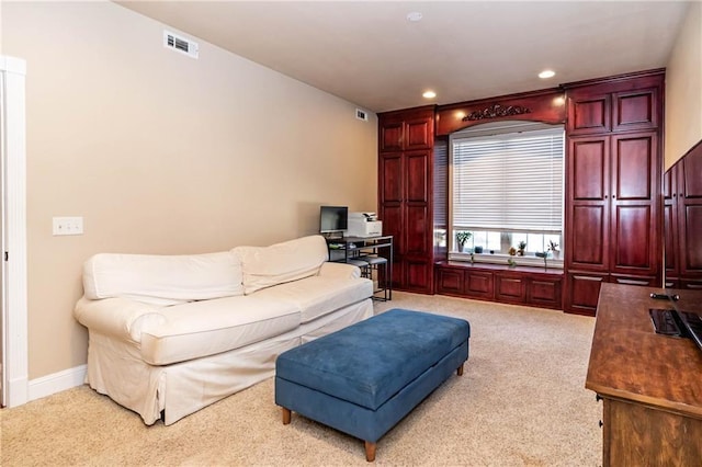 living room featuring recessed lighting, light colored carpet, visible vents, and baseboards