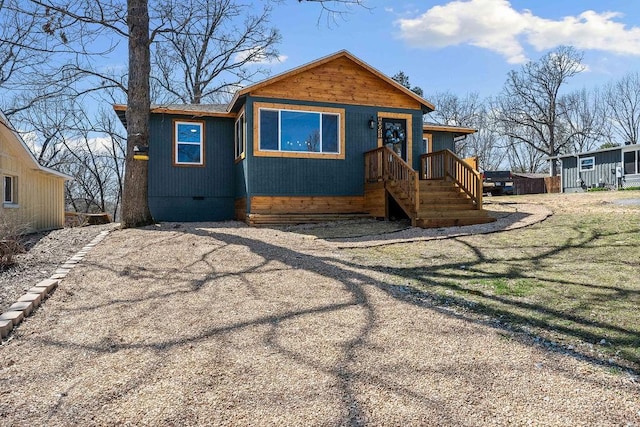 view of front facade with crawl space and a front lawn