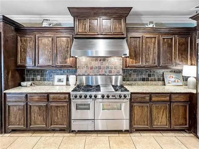 kitchen with double oven range, wall chimney exhaust hood, decorative backsplash, and ornamental molding