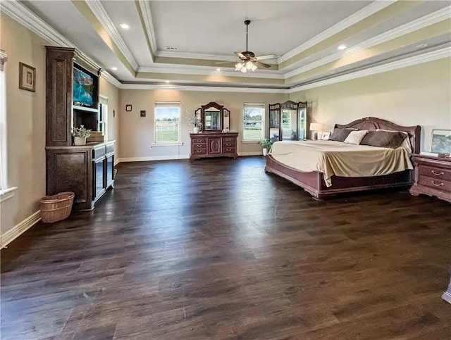 bedroom with a tray ceiling, baseboards, dark wood-type flooring, and ornamental molding