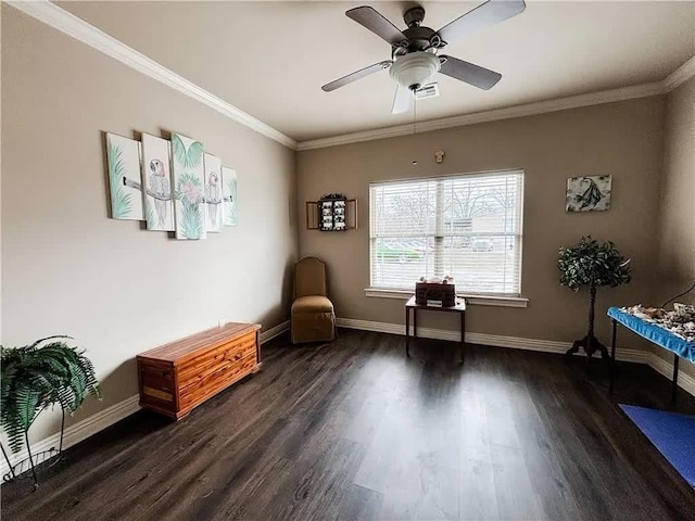 sitting room with a ceiling fan, crown molding, wood finished floors, and baseboards