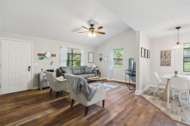 living room with a wealth of natural light, baseboards, dark wood finished floors, and vaulted ceiling