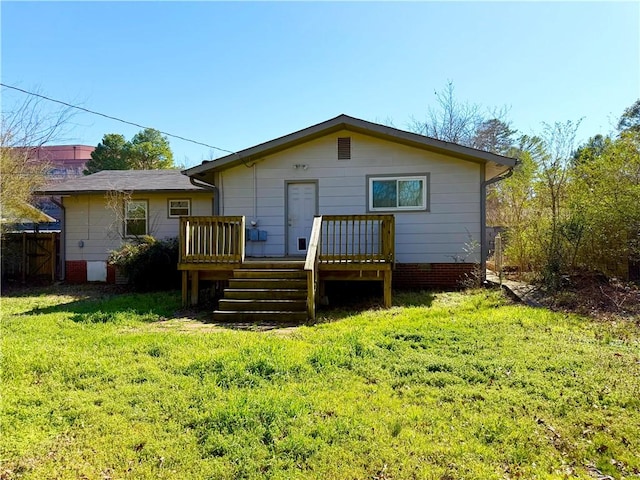 rear view of house featuring crawl space, a yard, fence, and a wooden deck