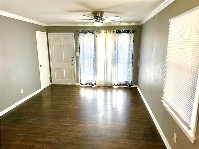 spare room featuring wood finished floors, baseboards, and ornamental molding