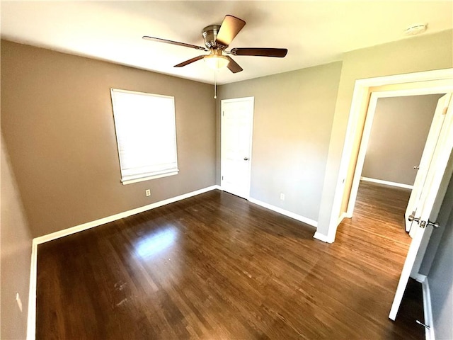 unfurnished bedroom with baseboards, ceiling fan, and dark wood-style flooring