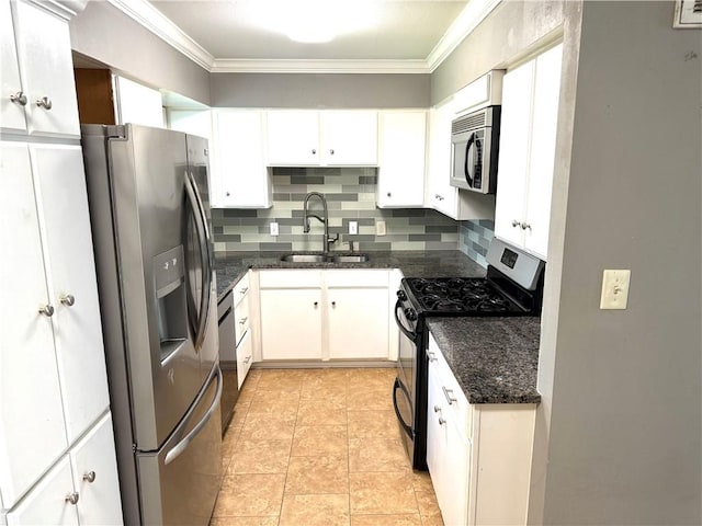 kitchen with ornamental molding, decorative backsplash, a sink, appliances with stainless steel finishes, and white cabinetry