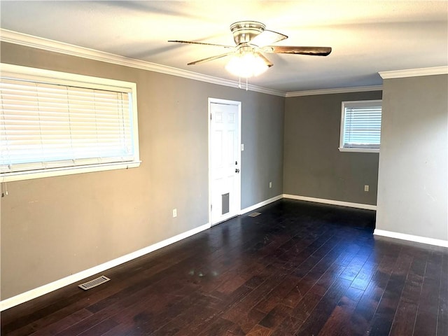 spare room featuring visible vents, hardwood / wood-style floors, crown molding, baseboards, and ceiling fan