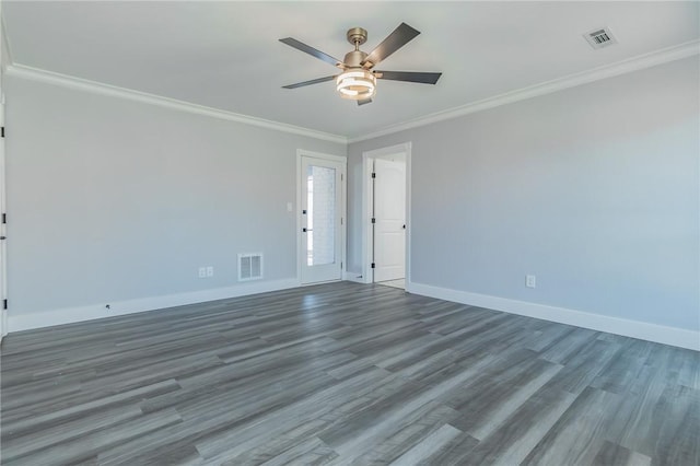 unfurnished room with visible vents, baseboards, and crown molding