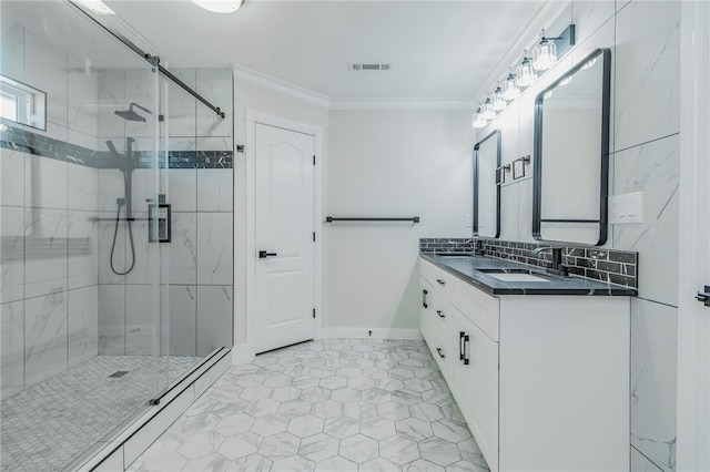 bathroom featuring a sink, a shower stall, visible vents, and ornamental molding