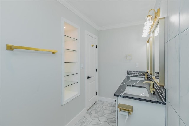 bathroom with ornamental molding, a sink, tile patterned flooring, double vanity, and baseboards