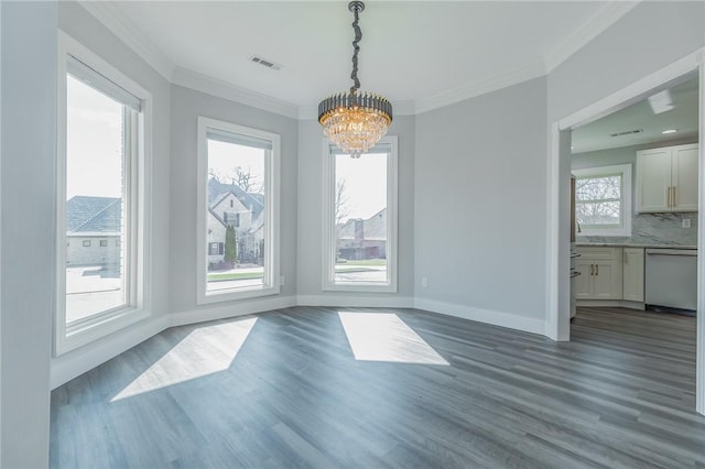 unfurnished dining area featuring visible vents, baseboards, dark wood finished floors, ornamental molding, and a chandelier