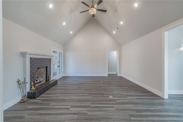 unfurnished living room with wood finished floors, a ceiling fan, baseboards, high vaulted ceiling, and a brick fireplace