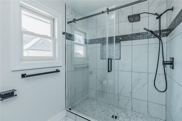 full bathroom featuring baseboards and a stall shower