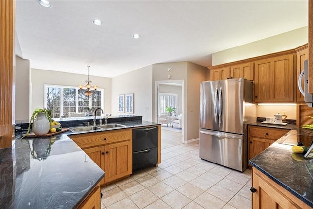 kitchen with light tile patterned floors, a healthy amount of sunlight, appliances with stainless steel finishes, and a sink