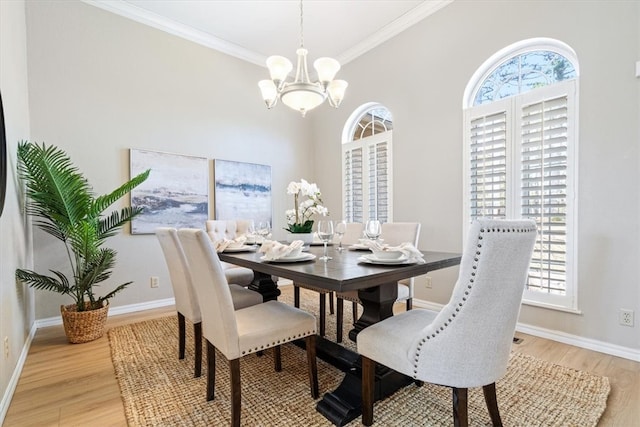 dining area with crown molding, a notable chandelier, baseboards, and light wood finished floors