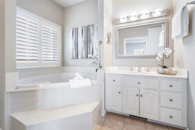 full bath featuring visible vents, a garden tub, vanity, and tile patterned flooring