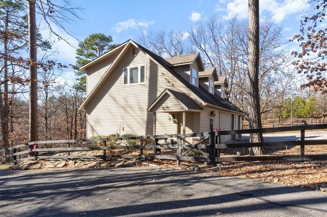 view of side of property featuring a fenced front yard and an attached garage