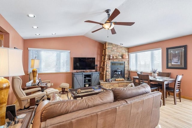 living area featuring baseboards, lofted ceiling, light wood-style flooring, recessed lighting, and ceiling fan