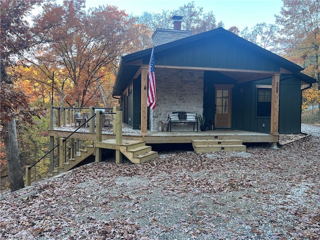 view of home's exterior featuring stone siding, board and batten siding, and a chimney