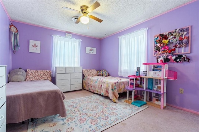 carpeted bedroom with baseboards, a textured ceiling, a ceiling fan, and crown molding