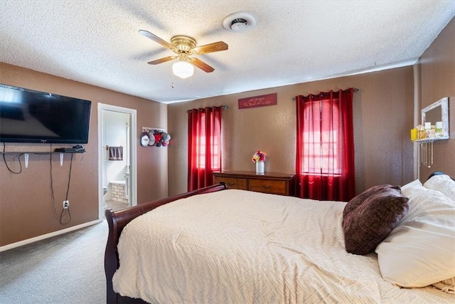 bedroom with baseboards, carpet, ensuite bathroom, a textured ceiling, and a ceiling fan