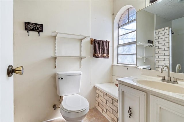 bathroom with a healthy amount of sunlight, toilet, and vanity