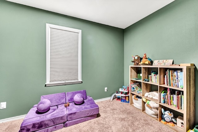 rec room featuring baseboards and carpet floors