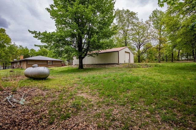 view of yard featuring an outbuilding, a garage, and a pole building